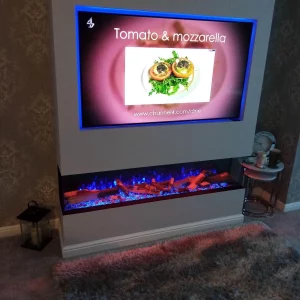 Media Wall with Purple Fire Effect and Neon Strip Lighting Surrounding the TV