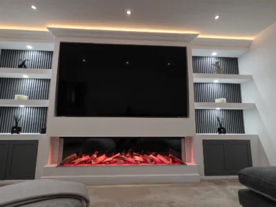 Bespoke media wall featuring a large TV, electric fireplace and LED lighting