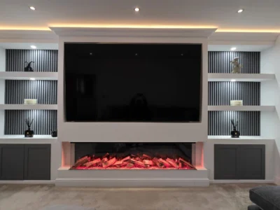 Contemporary living room media wall with electric fire and custom shelving